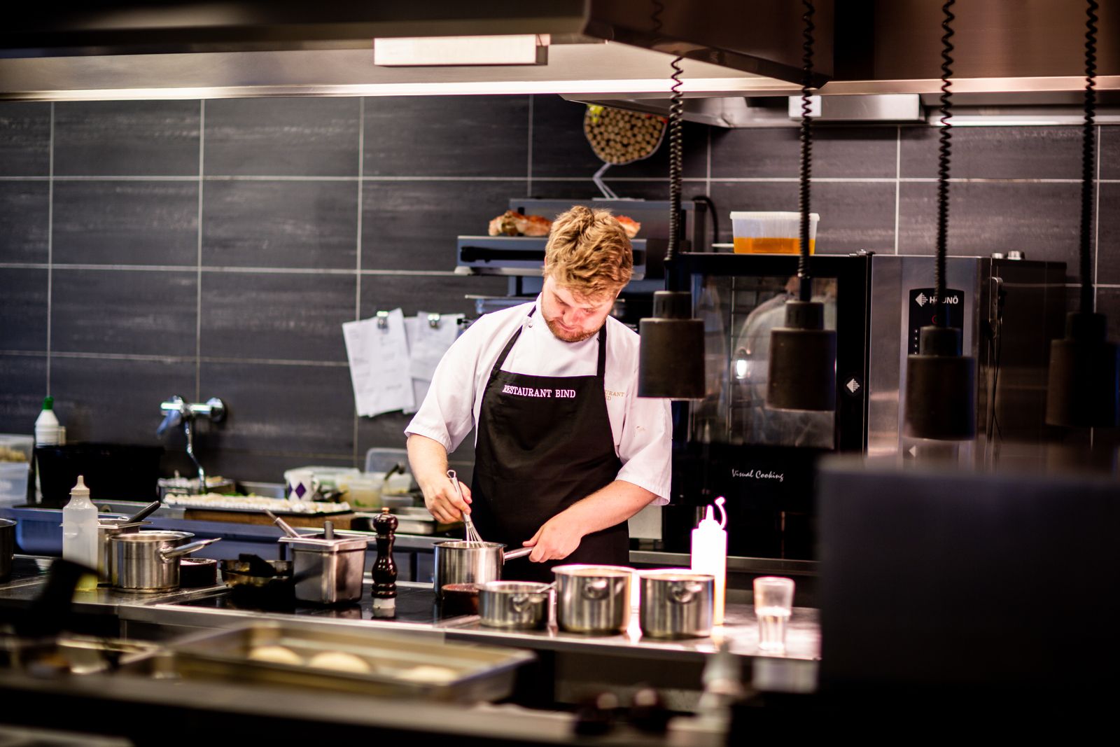 Professional cook preparing a meal in a Pakistani kitchen